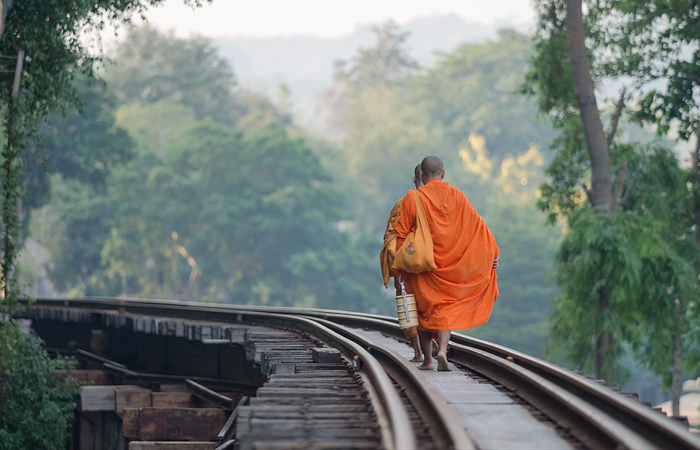 The monks walking on the Death Railway Kanchanaburi Thailand
